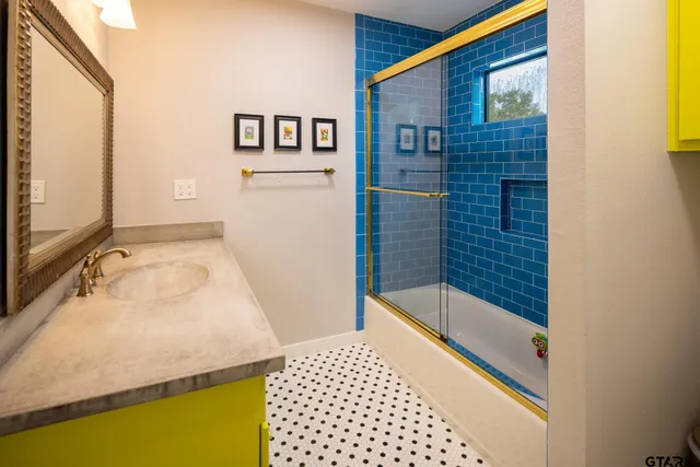 a en suite bathroom with a sink and mirror