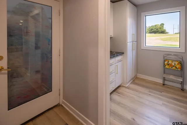 a utility room with sink dryer and washer