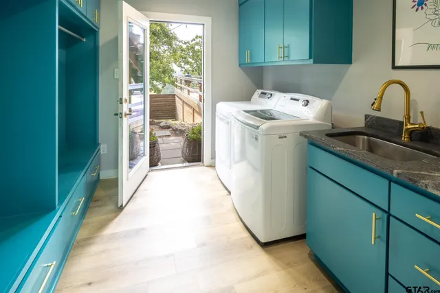 a view of a patio with table and chairs and potted plants with large tree
