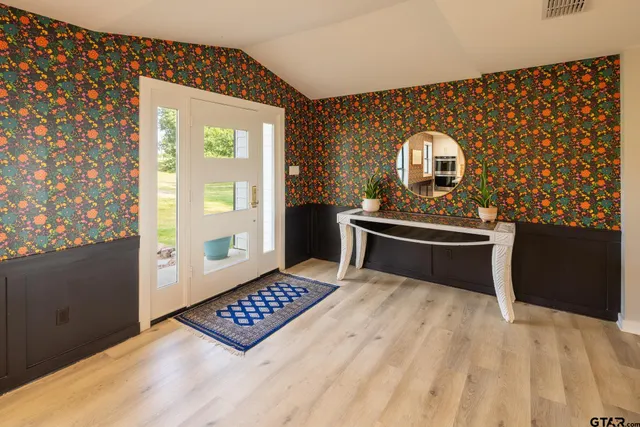 a view of kitchen with stove and refrigerator