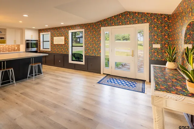 a view of kitchen with kitchen island wooden cabinets and refrigerator