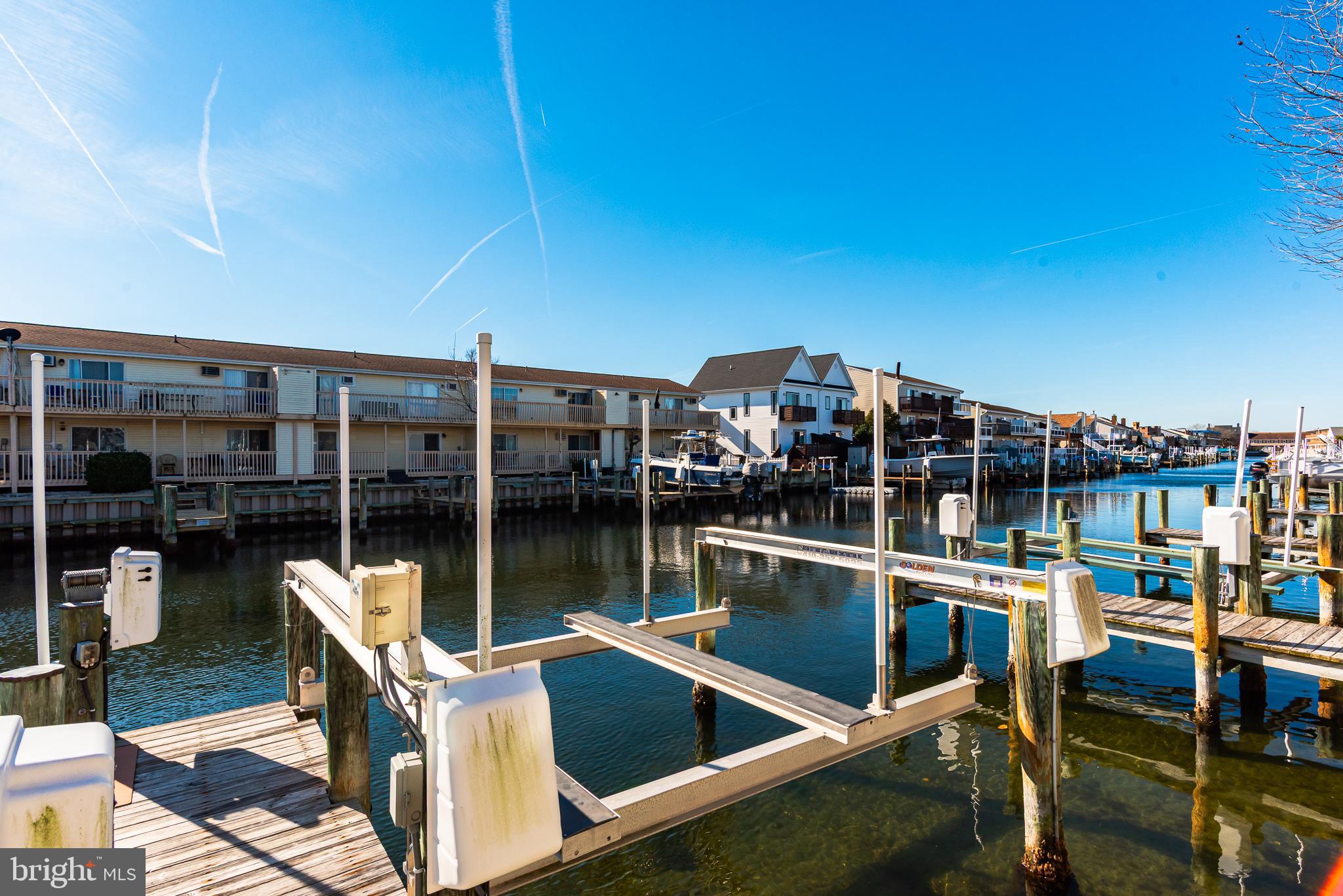 131 Newport Bay Drive, Unit 2 Ocean City, MD 21842 - Photo 15 of 61 a view of a chairs and table on the terrace