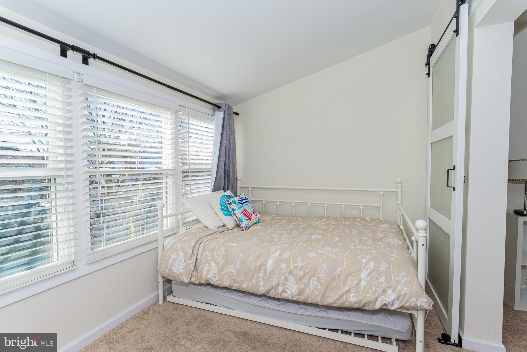 131 Newport Bay Drive, Unit 2 Ocean City, MD 21842 - Photo 21 of 61 a bedroom with a bed and a window