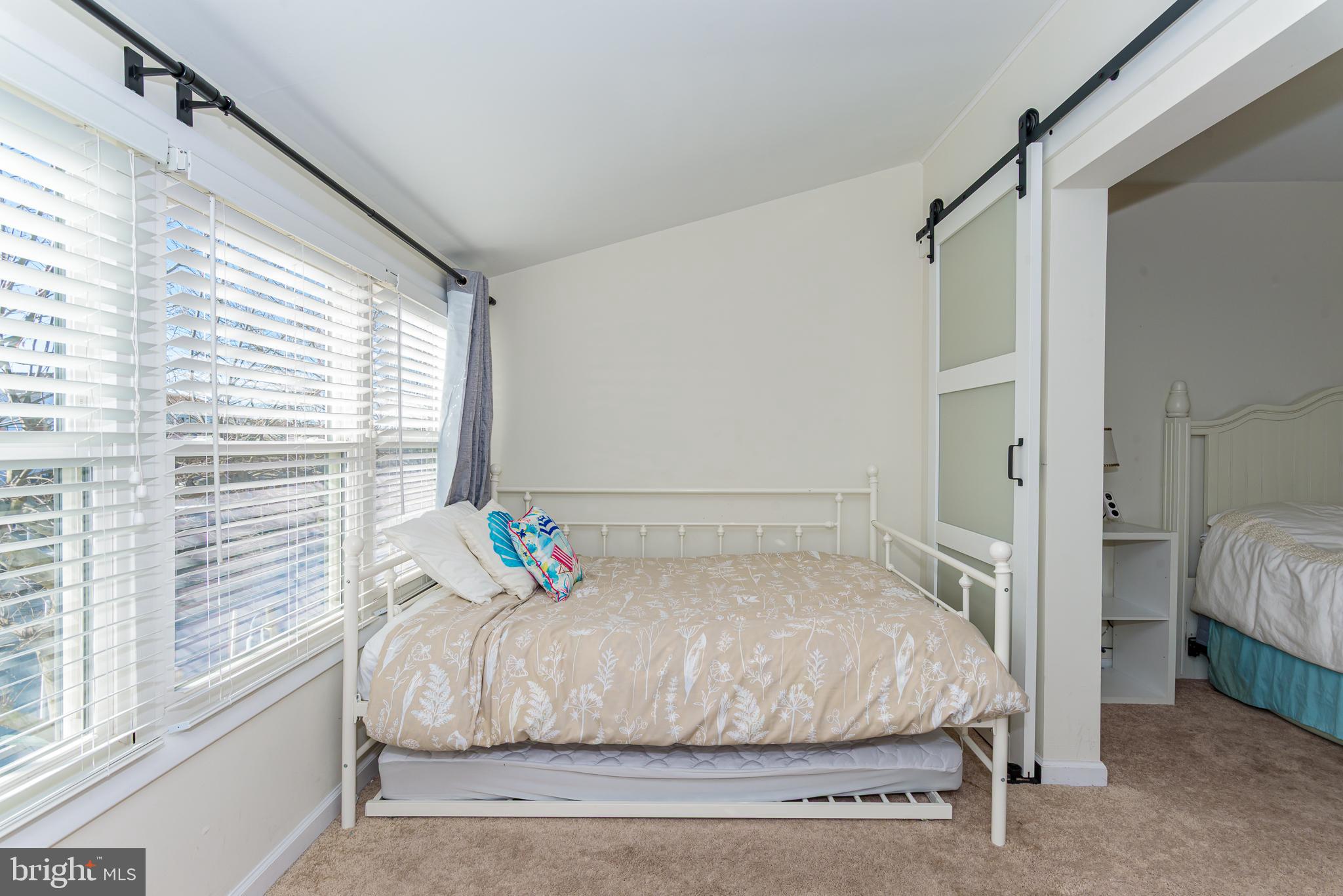 131 Newport Bay Drive, Unit 2 Ocean City, MD 21842 - Photo 22 of 61 a bedroom with a large bed and a window