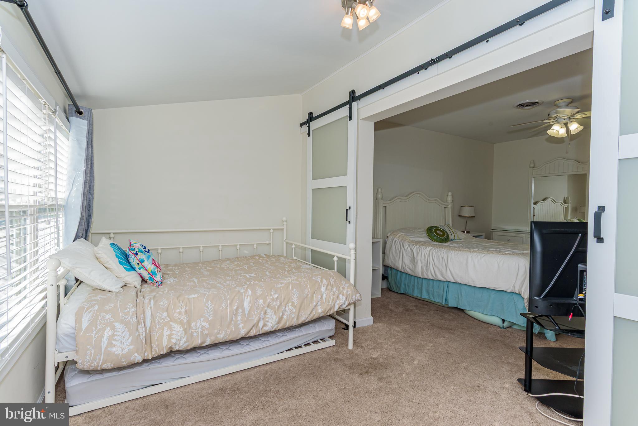 131 Newport Bay Drive, Unit 2 Ocean City, MD 21842 - Photo 23 of 61 a bedroom with a bed and a window
