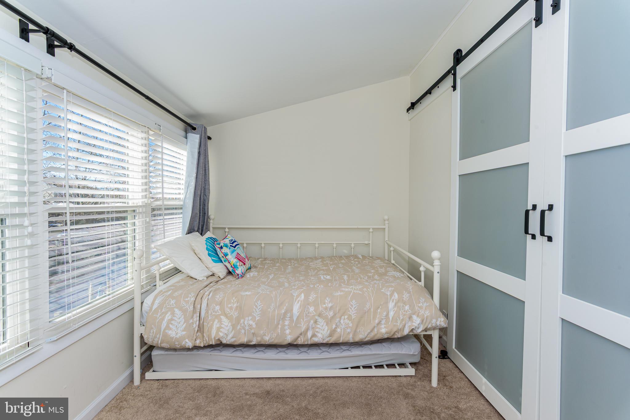 131 Newport Bay Drive, Unit 2 Ocean City, MD 21842 - Photo 24 of 61 a bedroom with a bed and a window with the outer view