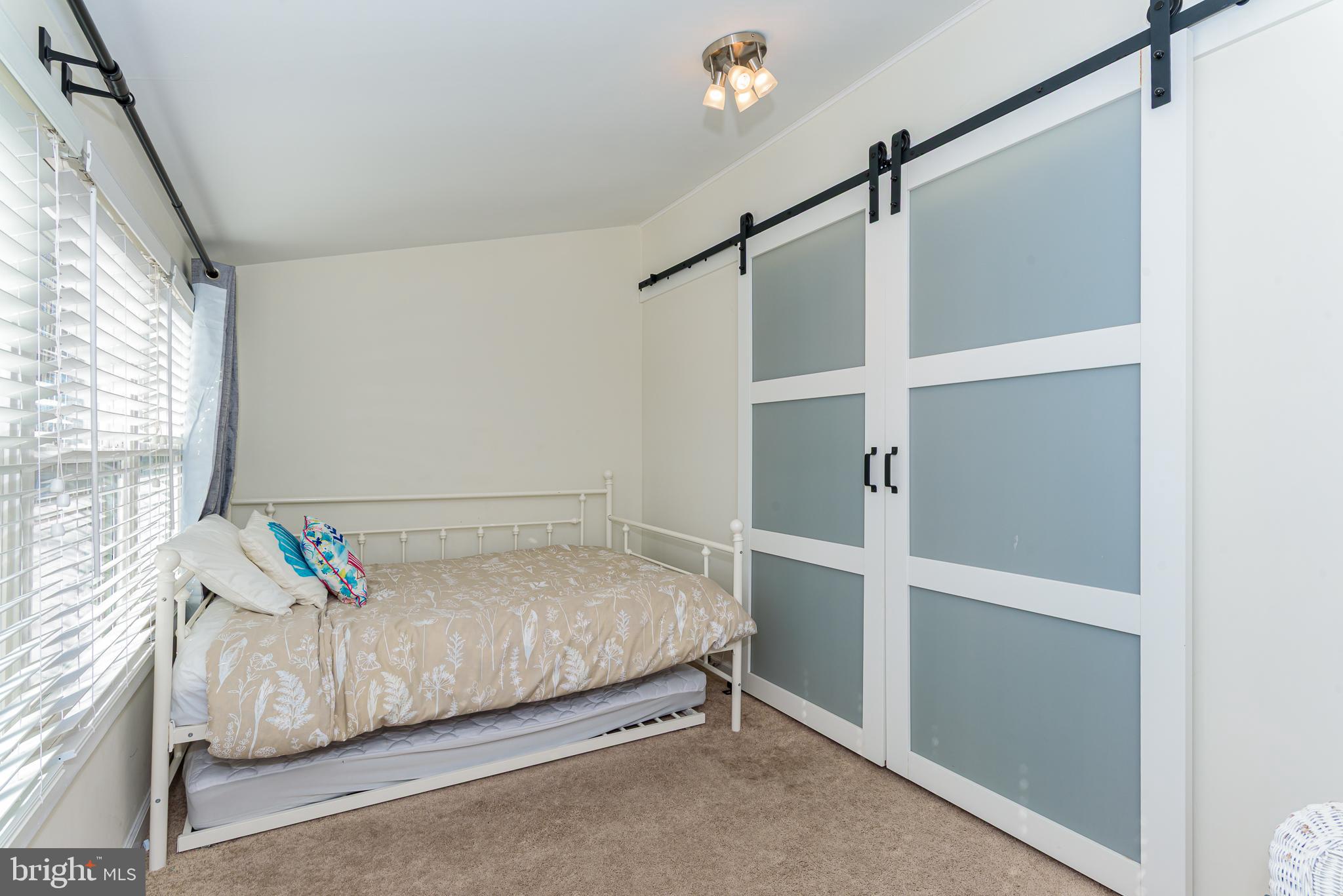 131 Newport Bay Drive, Unit 2 Ocean City, MD 21842 - Photo 25 of 61 a bedroom with a bed and a window