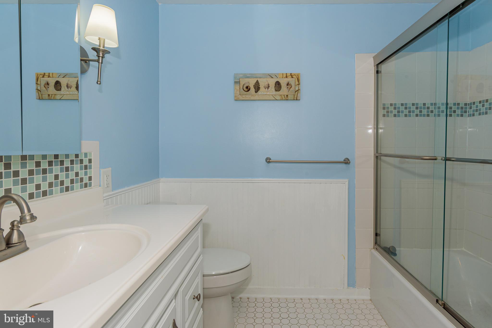 131 Newport Bay Drive, Unit 2 Ocean City, MD 21842 - Photo 34 of 61 a bathroom with a sink a toilet and shower