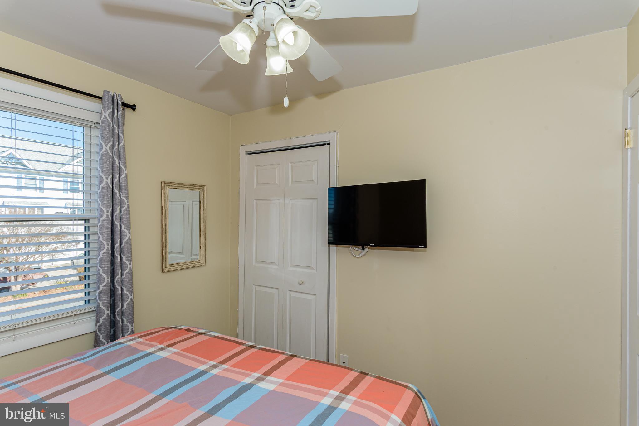 131 Newport Bay Drive, Unit 2 Ocean City, MD 21842 - Photo 38 of 61 a bedroom with a bed and a flat screen tv