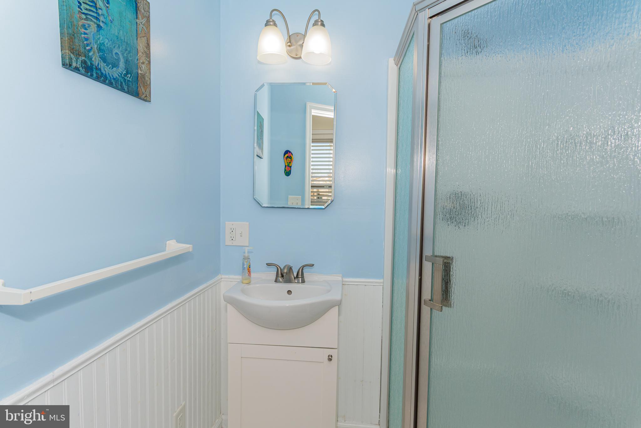 131 Newport Bay Drive, Unit 2 Ocean City, MD 21842 - Photo 41 of 61 a bathroom with a sink and a mirror