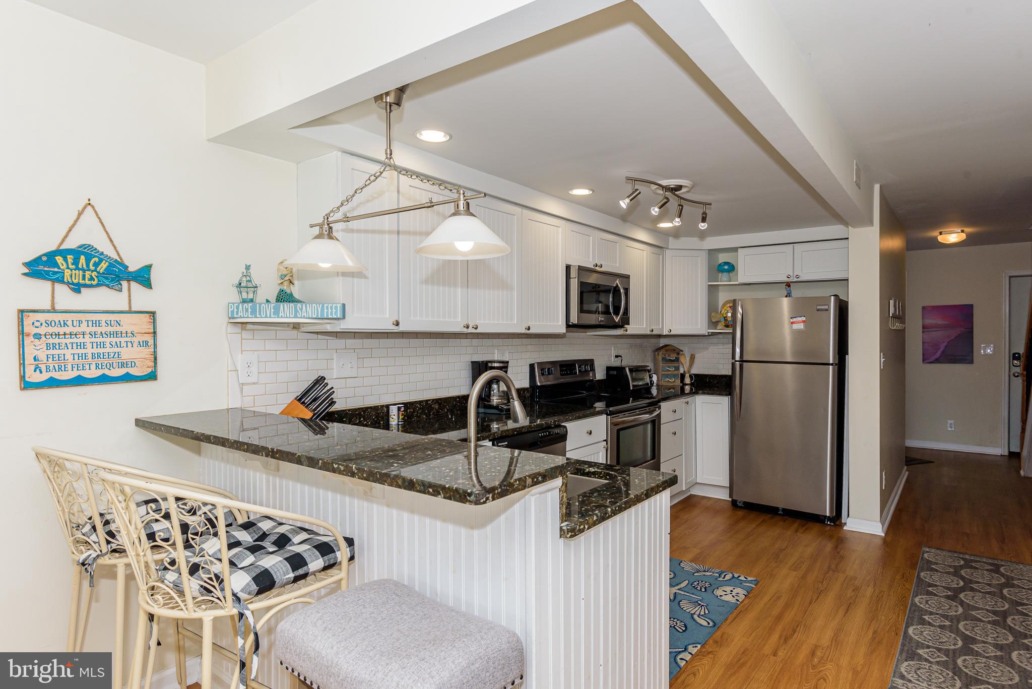 131 Newport Bay Drive, Unit 2 Ocean City, MD 21842 - Photo 47 of 61 a kitchen with refrigerator and cabinets