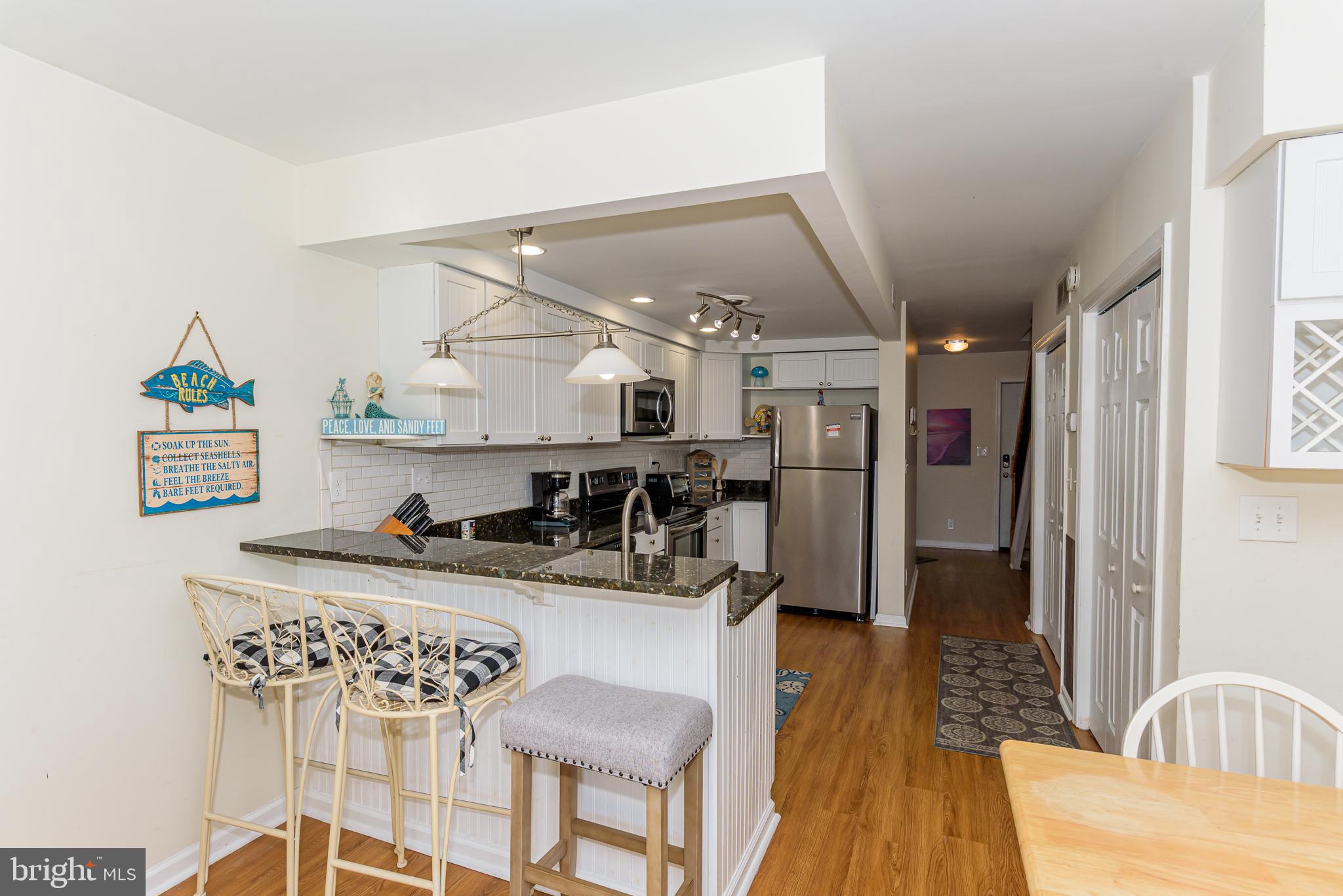 131 Newport Bay Drive, Unit 2 Ocean City, MD 21842 - Photo 48 of 61 a kitchen with stainless steel appliances granite countertop a sink stove and refrigerator