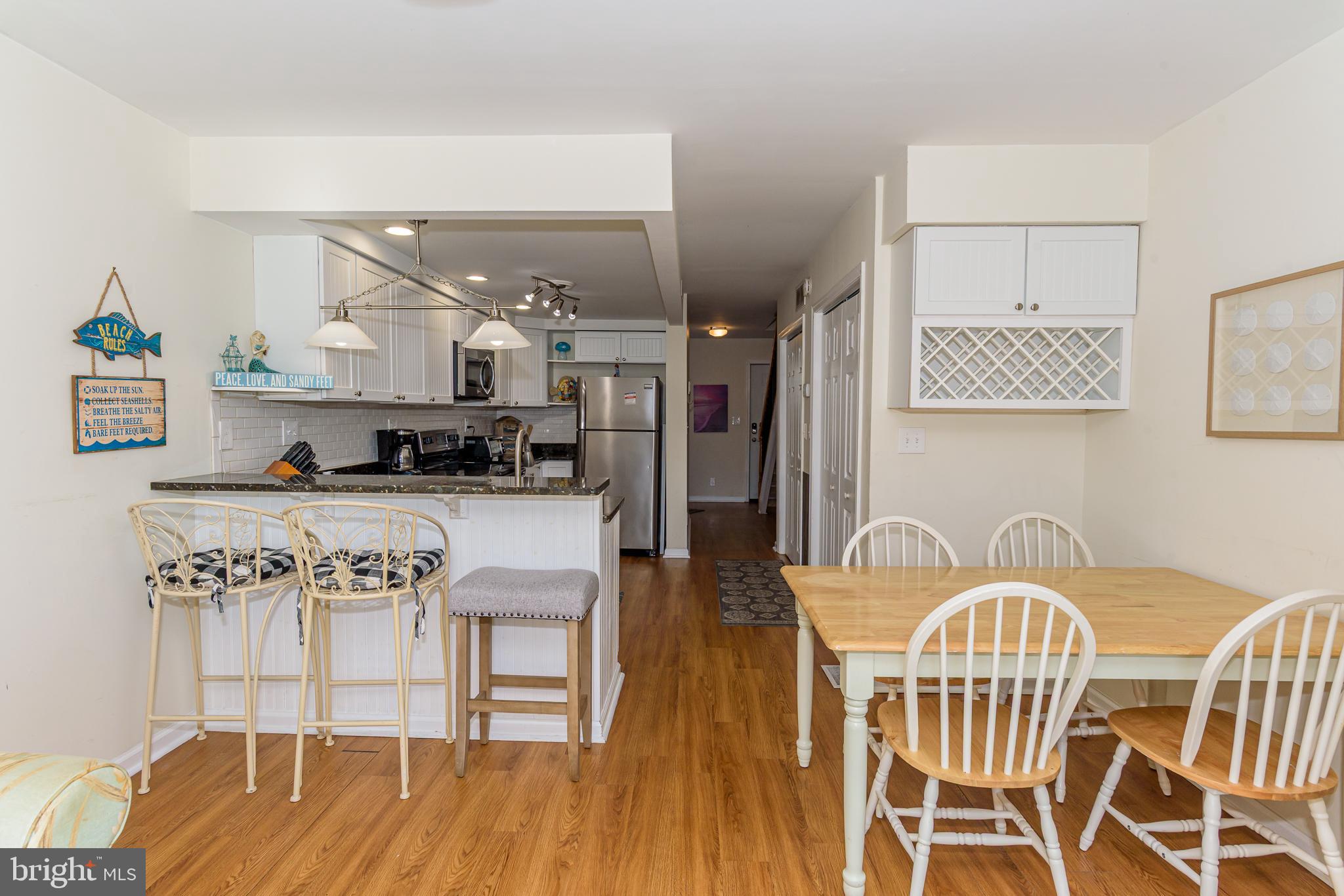 131 Newport Bay Drive, Unit 2 Ocean City, MD 21842 - Photo 50 of 61 a view of a dining room with furniture and wooden floor