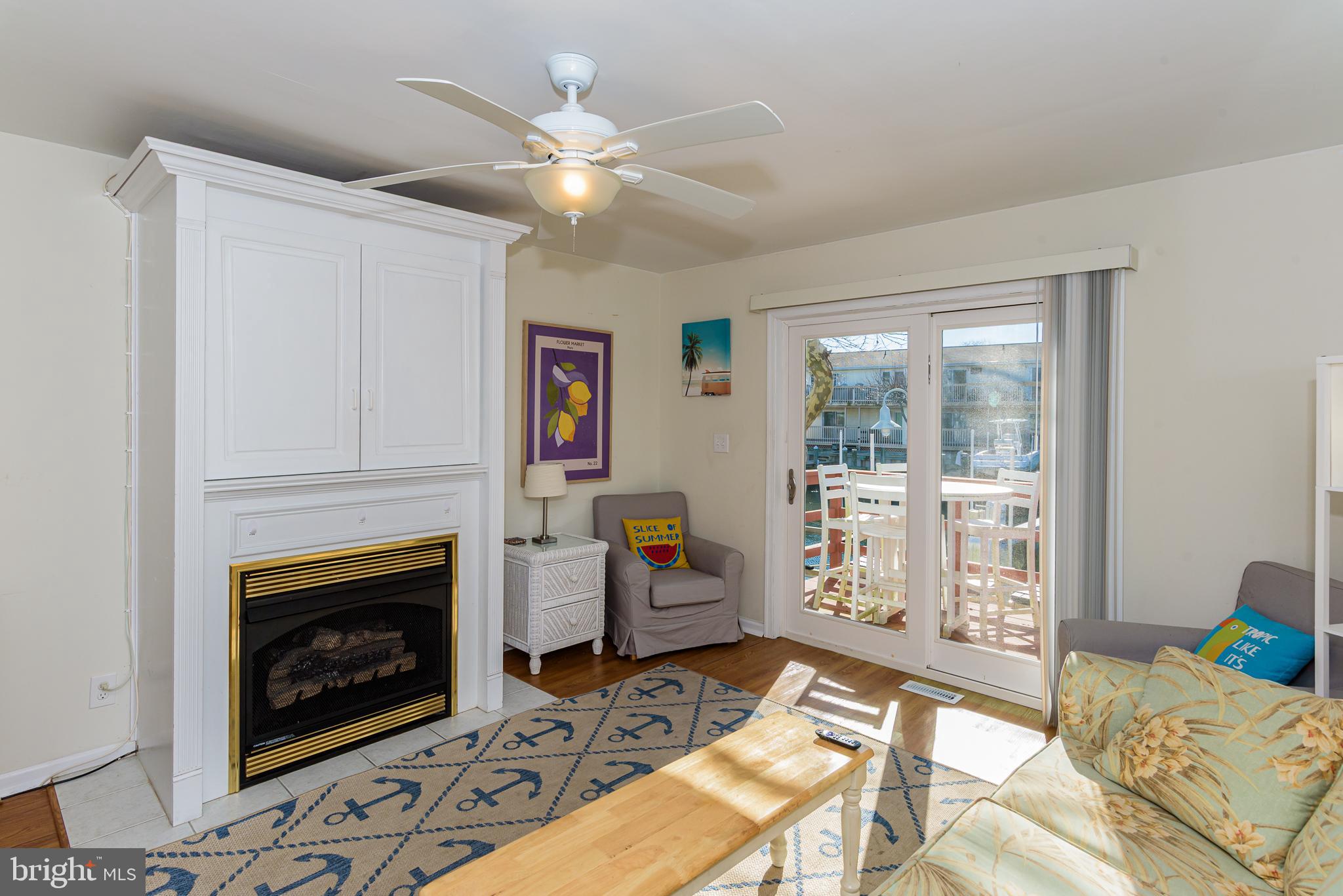 131 Newport Bay Drive, Unit 2 Ocean City, MD 21842 - Photo 53 of 61 a living room with furniture and a fireplace