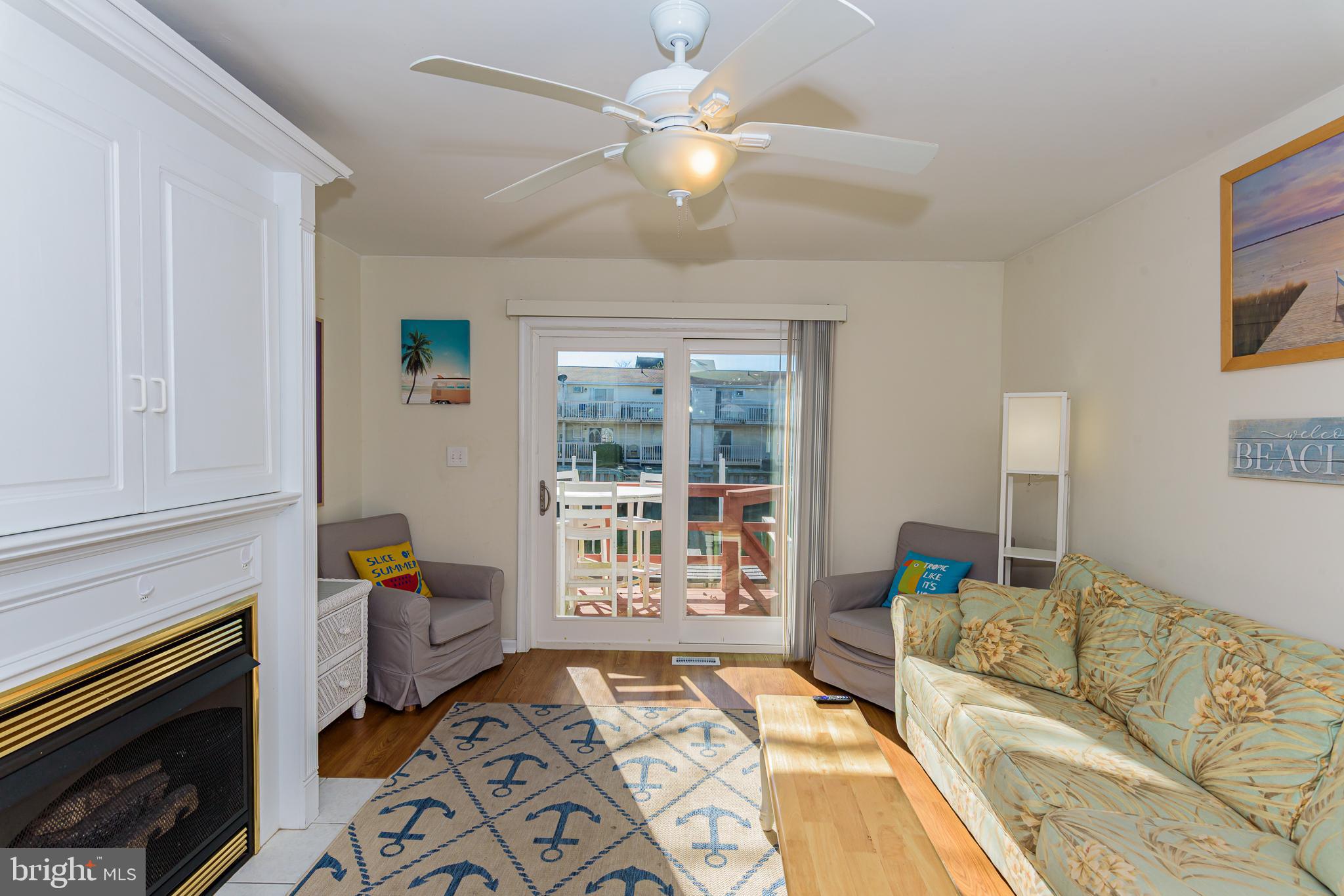 131 Newport Bay Drive, Unit 2 Ocean City, MD 21842 - Photo 54 of 61 a living room with furniture and a fireplace