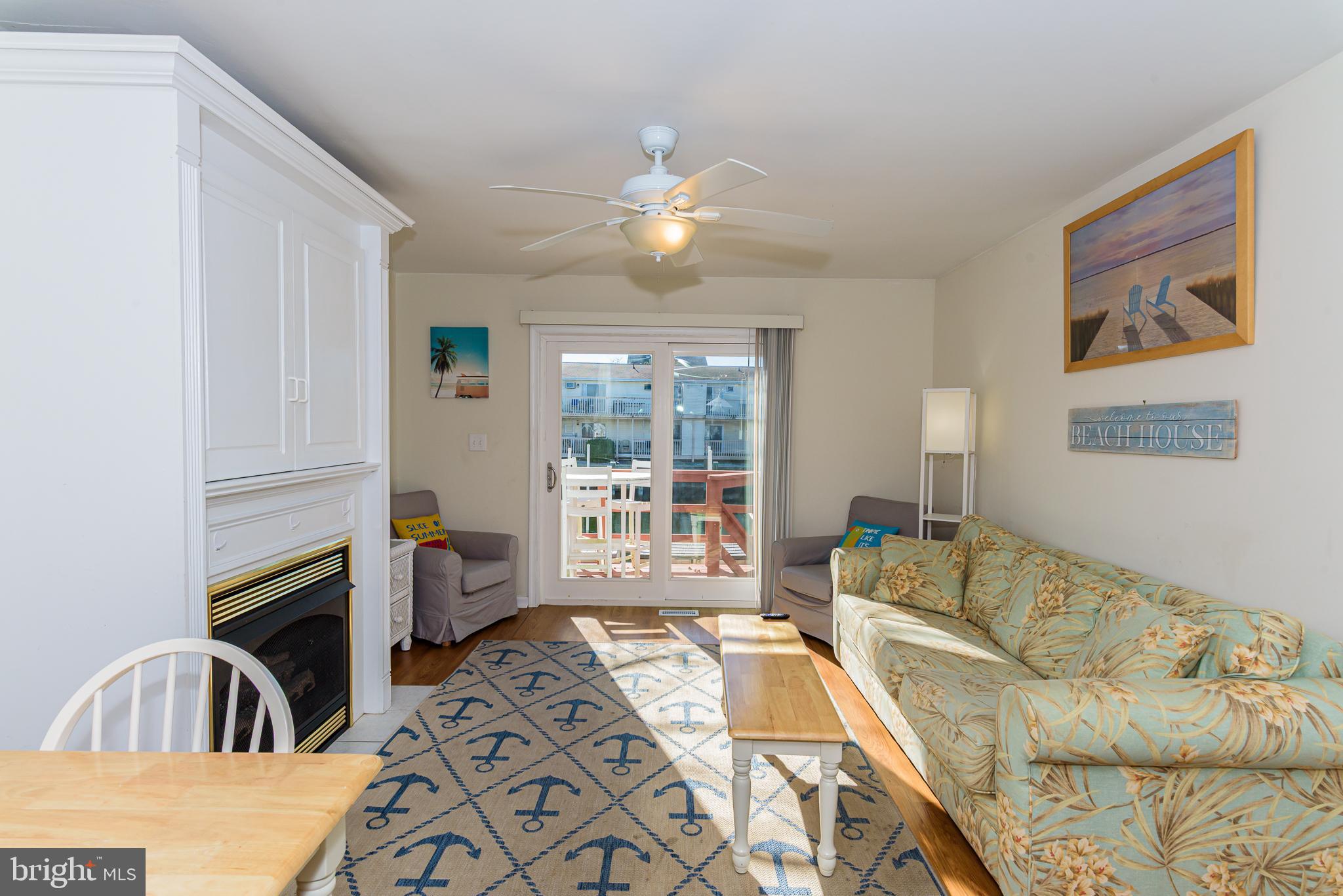 131 Newport Bay Drive, Unit 2 Ocean City, MD 21842 - Photo 61 of 61 a living room with furniture and a large window