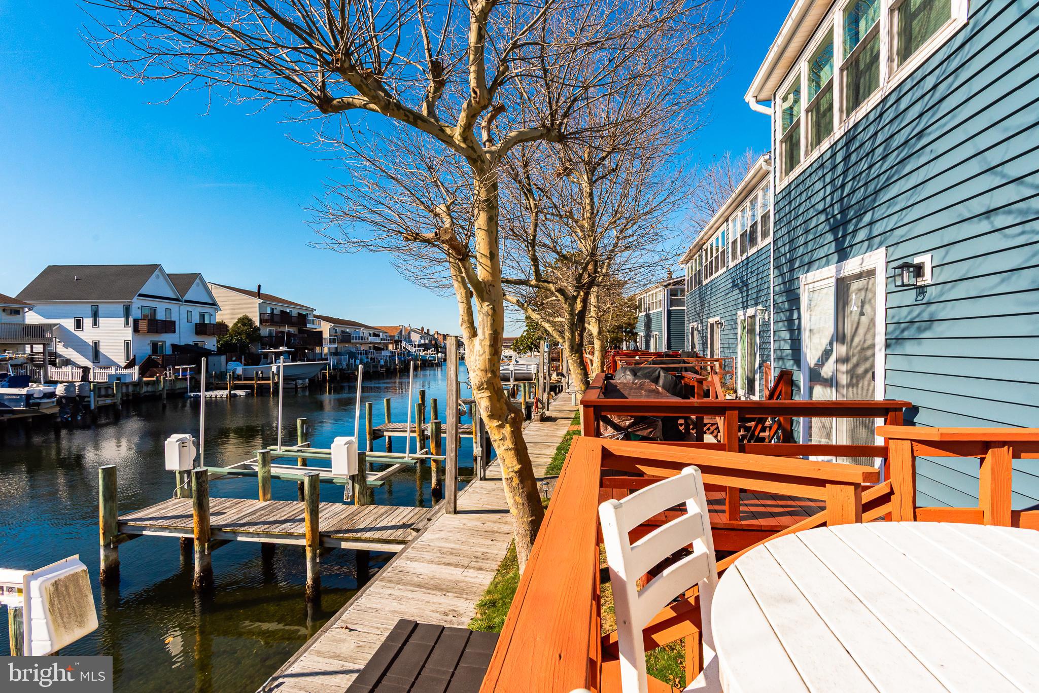 131 Newport Bay Drive, Unit 2 Ocean City, MD 21842 - Photo 9 of 61 a front view of a house with lake view and a floor to ceiling window