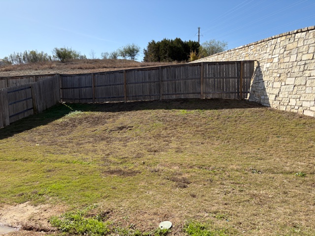 5601 Corso Court Austin, TX 78747 - Photo 16 of 18 a view of backyard with wooden fence