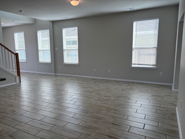 5601 Corso Court Austin, TX 78747 - Photo 4 of 18 an empty room with wooden floor and windows