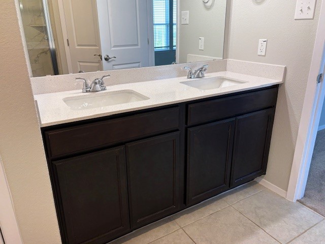5601 Corso Court Austin, TX 78747 - Photo 9 of 18 a bathroom with a sink and a mirror