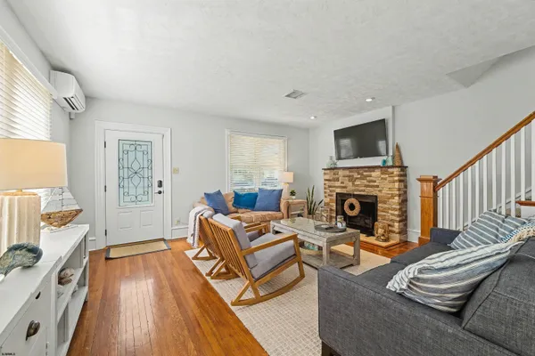 a dining room with furniture a chandelier and wooden floor