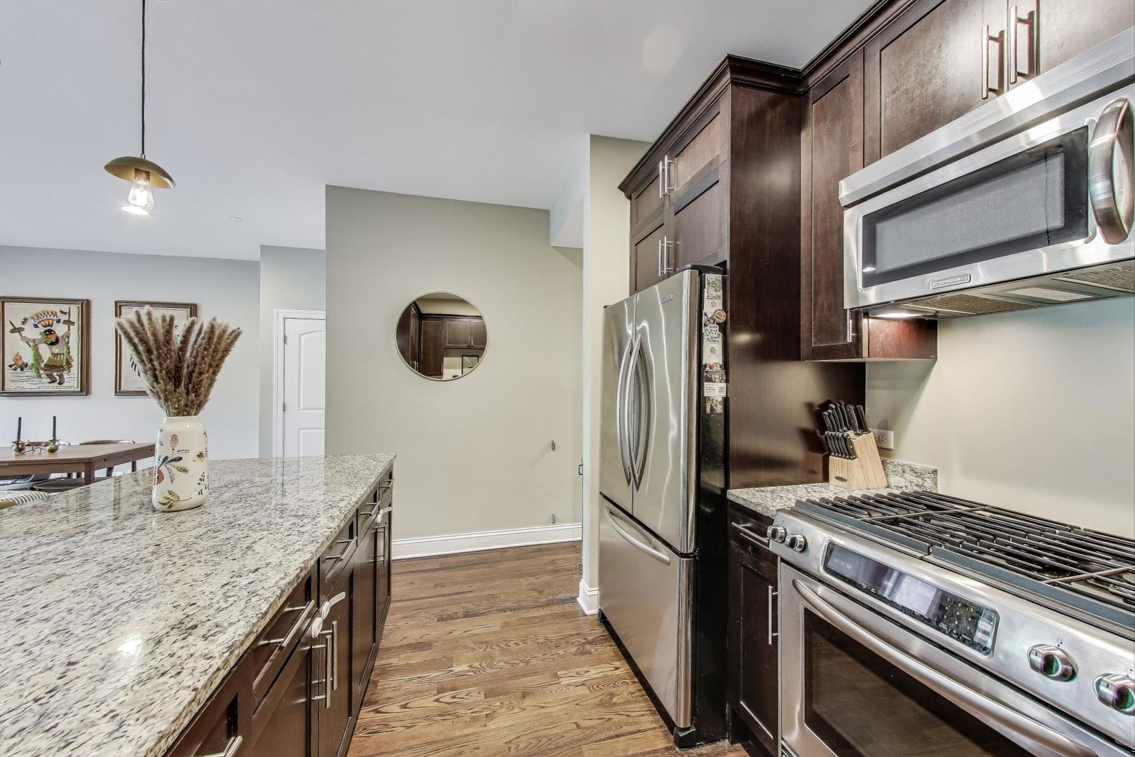 2120 West Rice Street, Unit 3 Chicago, IL 60622 - Photo 12 of 28 a kitchen with stainless steel appliances granite countertop a sink stove and refrigerator