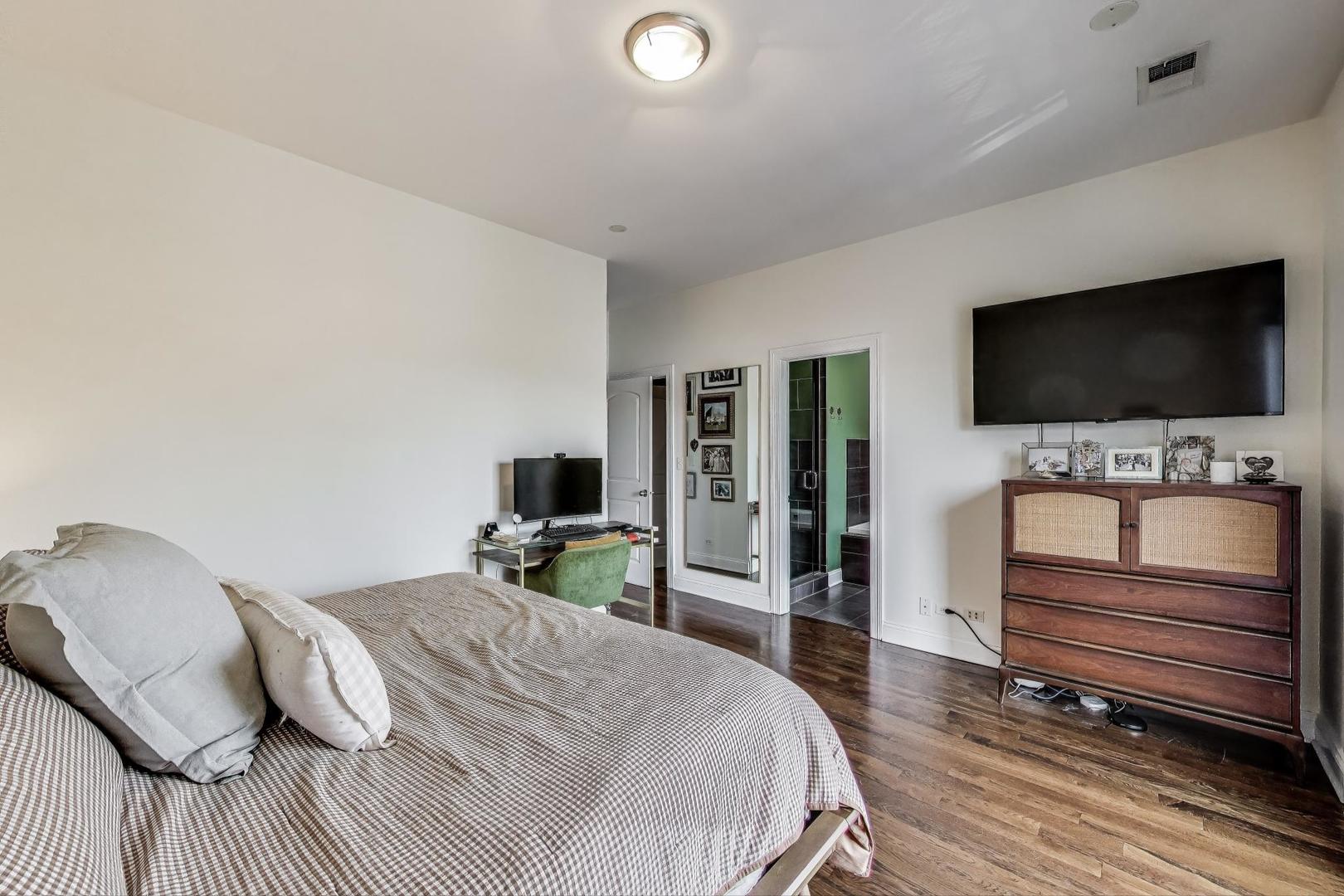 2120 West Rice Street, Unit 3 Chicago, IL 60622 - Photo 15 of 28 a bedroom with a bed and a flat screen tv