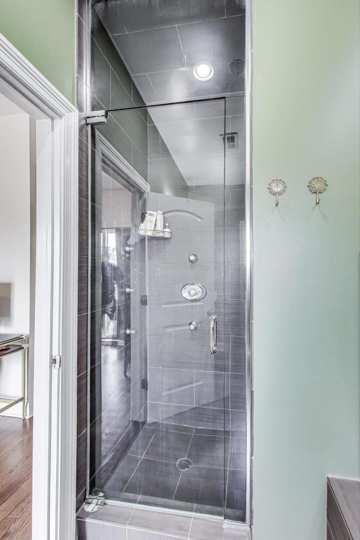 2120 West Rice Street, Unit 3 Chicago, IL 60622 - Photo 17 of 28 a bathroom with a glass shower door