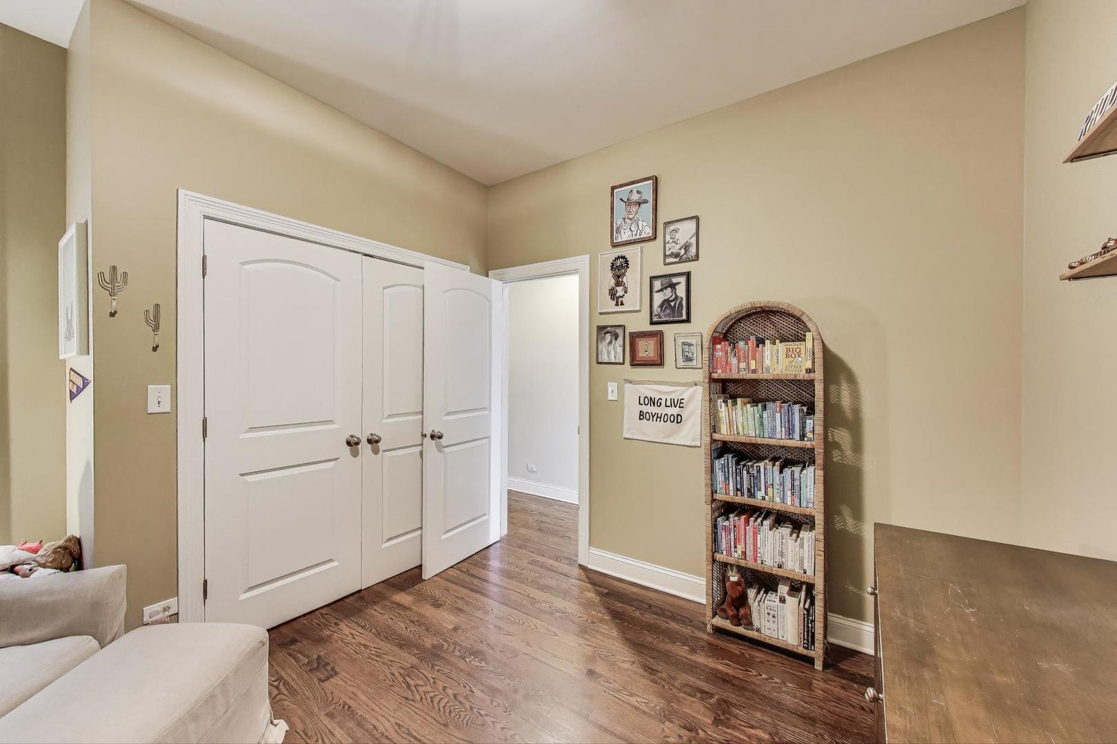 2120 West Rice Street, Unit 3 Chicago, IL 60622 - Photo 24 of 28 a view of a bedroom with a bookshelf and a window