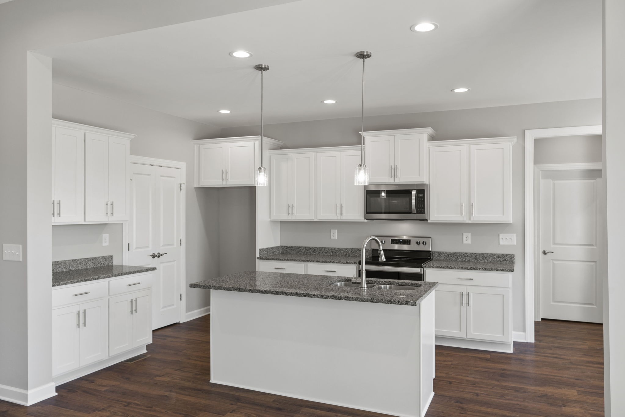 5557 Borthick Road Springfield, TN 37172 - Photo 15 of 48 a kitchen with stainless steel appliances granite countertop a refrigerator sink and white cabinets