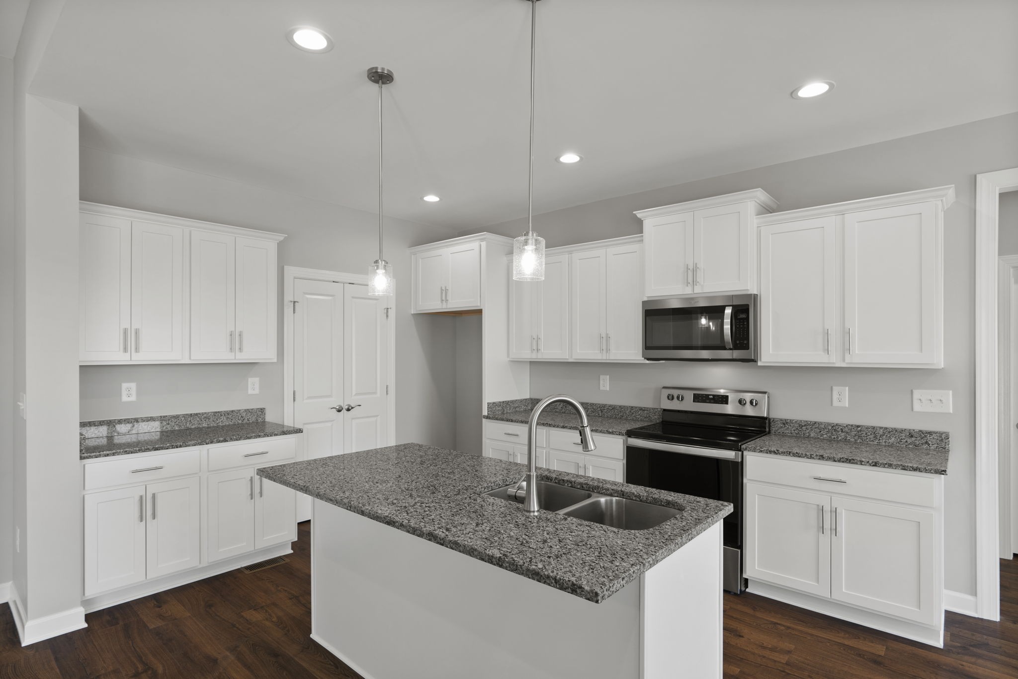 5557 Borthick Road Springfield, TN 37172 - Photo 17 of 48 a kitchen with granite countertop a sink stainless steel appliances and white cabinets