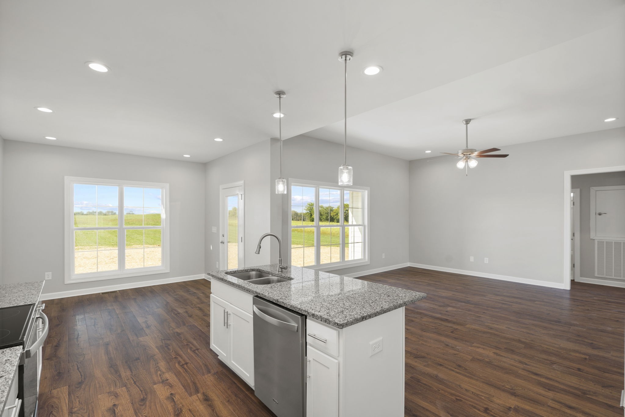 5557 Borthick Road Springfield, TN 37172 - Photo 20 of 48 a kitchen with granite countertop a stove a sink a window and wooden floor