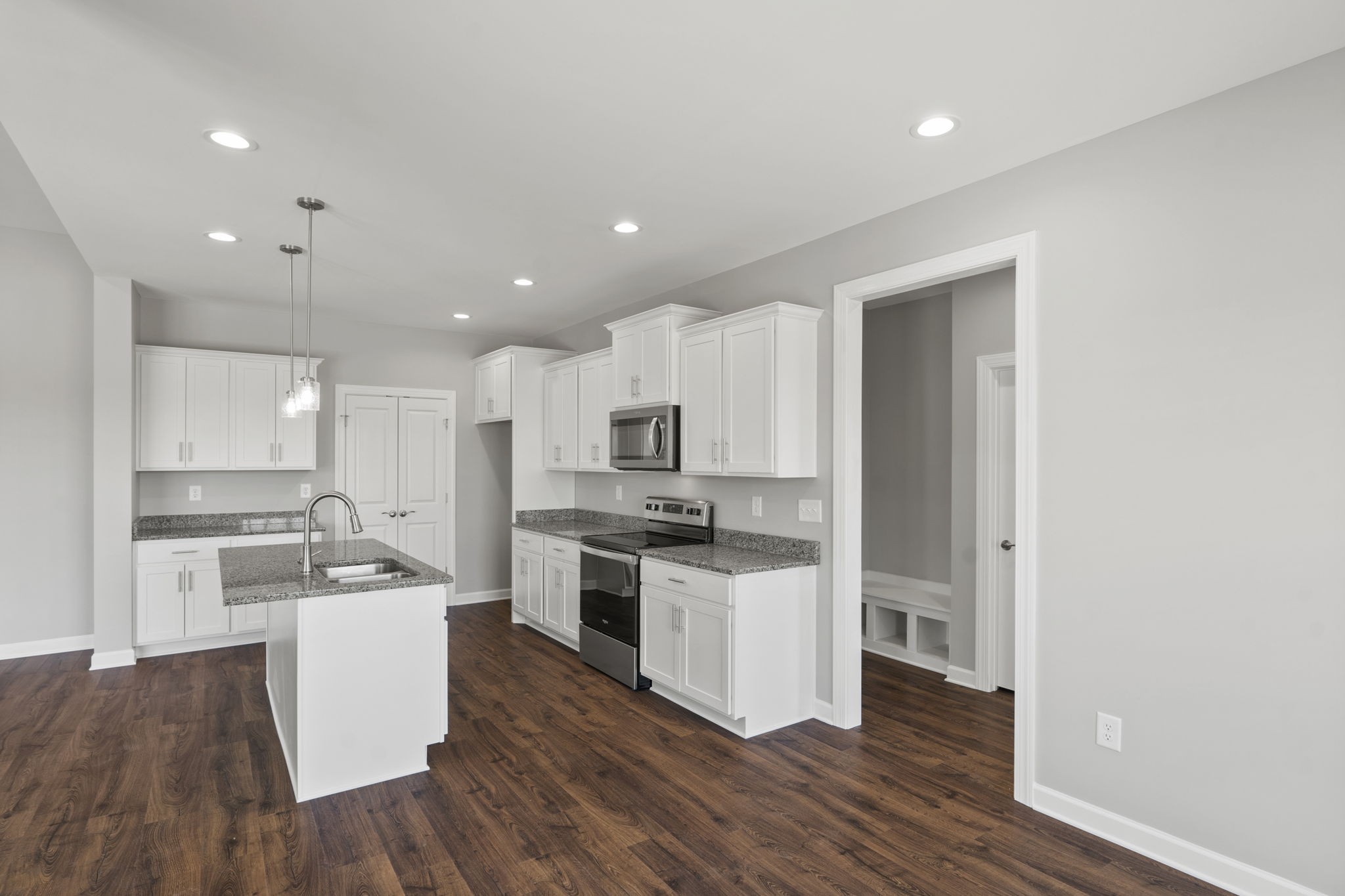 5557 Borthick Road Springfield, TN 37172 - Photo 22 of 48 a kitchen with white cabinets and stainless steel appliances