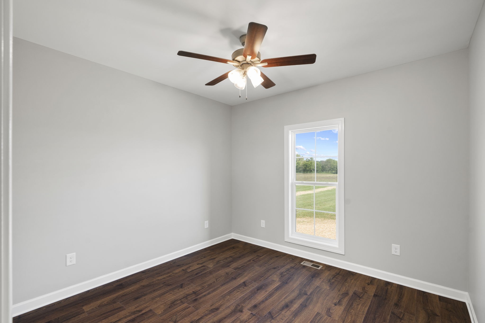 5557 Borthick Road Springfield, TN 37172 - Photo 32 of 48 an empty room with wooden floor fan and windows