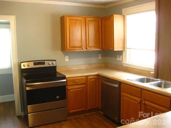 a kitchen with a sink stove and cabinets