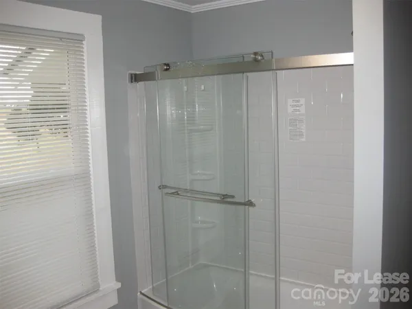 a bathroom with a shower and a bath tub