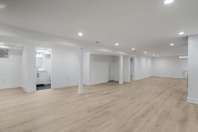 a view of an empty room with wooden floor
