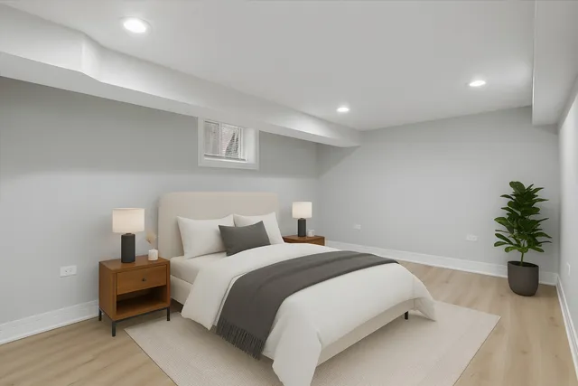 a bedroom with a bed and a potted plant