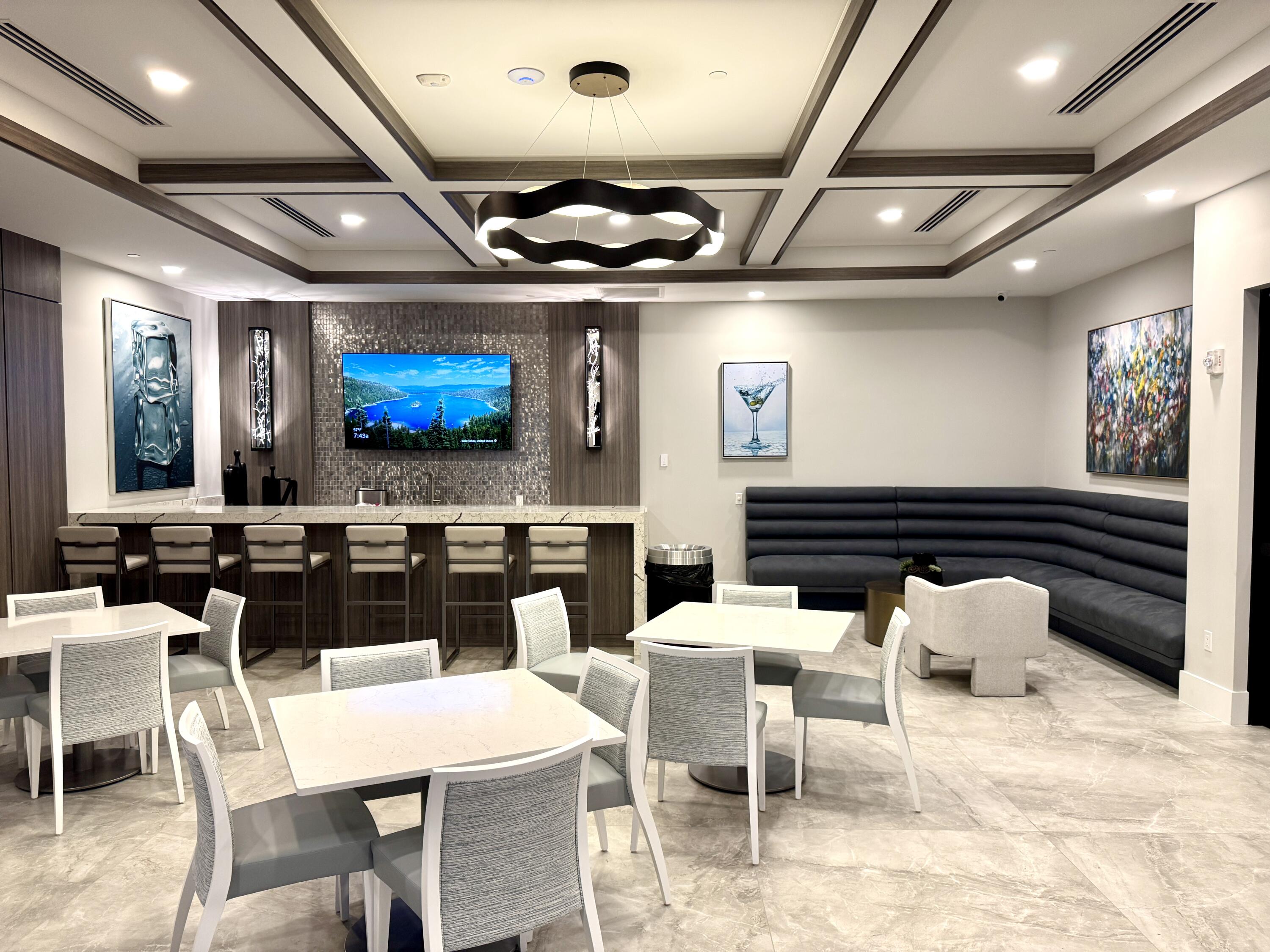 9385 Ivory Isle Road Boynton Beach, FL 33473 - Photo 39 of 50 a group of furniture a rug and a projector in a room