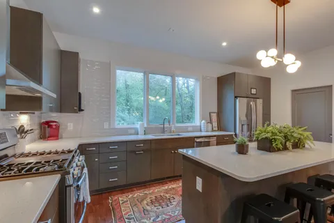 a kitchen with a stove a sink and a refrigerator