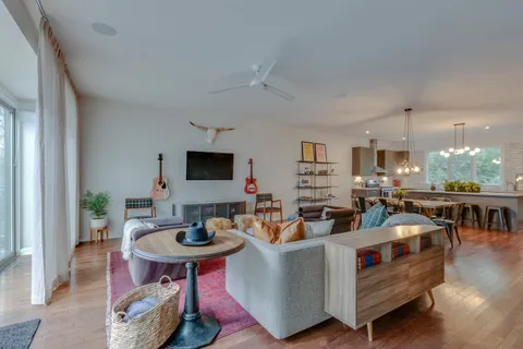 a living room with furniture a wooden floor and a table