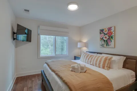 a bedroom with a bed and a flat screen tv