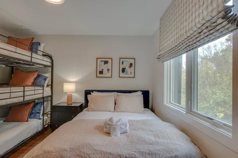 a bedroom with a bed and a window