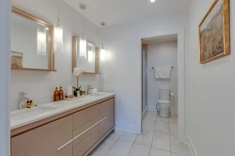 a bathroom with a sink a toilet and a mirror