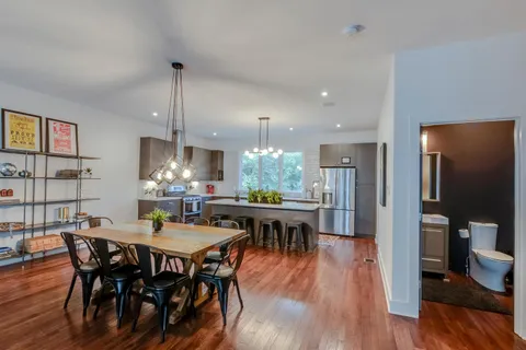a view of a dining room with furniture window and wooden floor