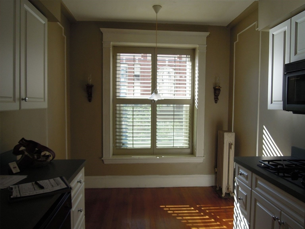8 Garrison Street, Unit 209 Boston, MA 02116 - Photo 27 of 33 a kitchen with a stove and a window