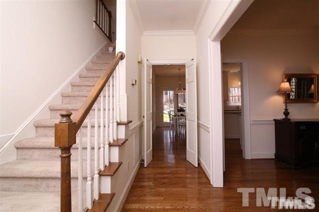 805 Thatcher Way Raleigh, NC 27615 - Photo 3 of 25 a view of a hallway with wooden floor and staircase