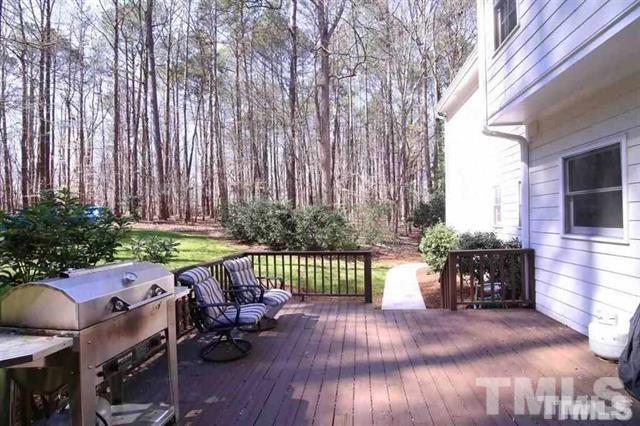 805 Thatcher Way Raleigh, NC 27615 - Photo 21 of 25 a view of a patio with table and chairs with wooden floor and fence