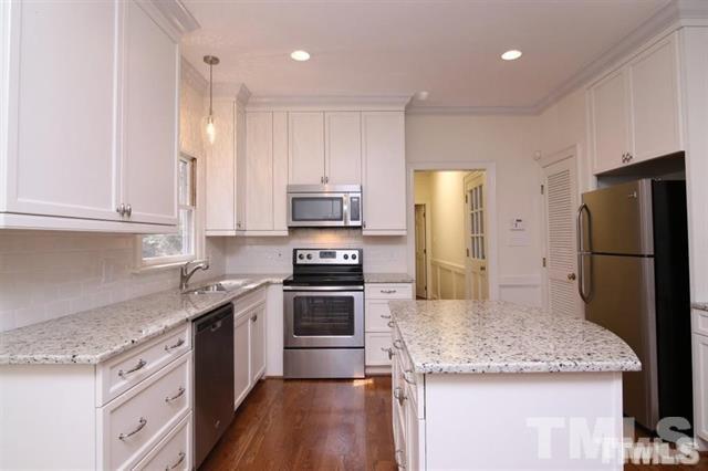 805 Thatcher Way Raleigh, NC 27615 - Photo 9 of 25 a kitchen with stainless steel appliances granite countertop a refrigerator sink and stove