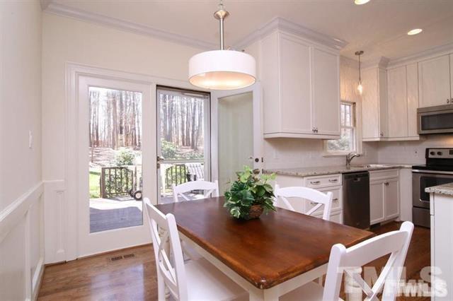 805 Thatcher Way Raleigh, NC 27615 - Photo 10 of 25 a kitchen with stainless steel appliances granite countertop a stove a sink a microwave and a refrigerator